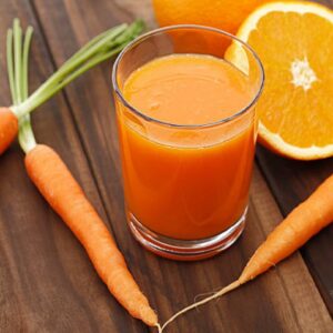 Mixed orange and carrot juice on wooden background